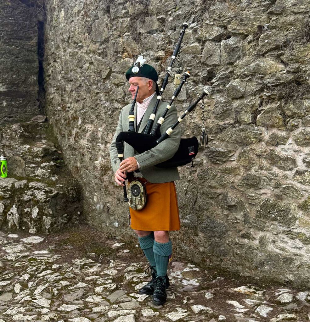 Bagpiper at the foot of Blarney Castle